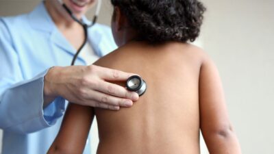 provider examines child with stethoscope