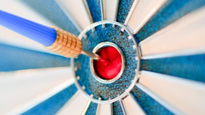 Dart board with dart in the bullseye