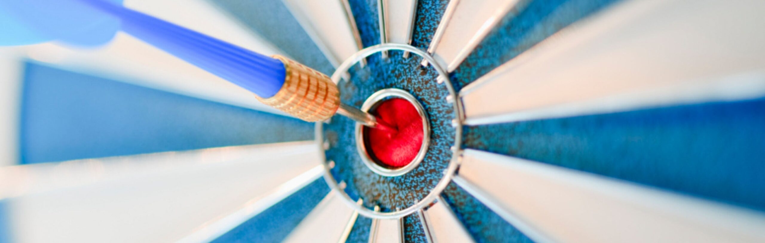 Dart board with dart in the bullseye