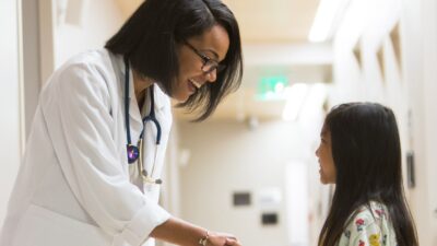 Physician smiles at girl patient