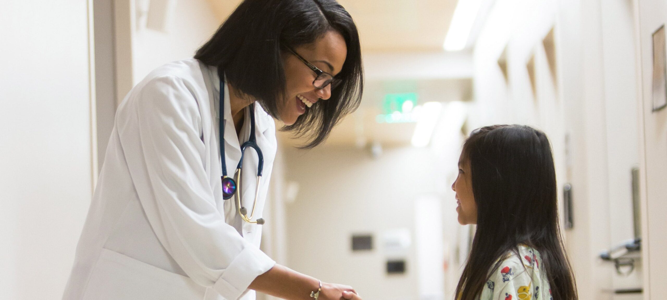 Physician smiles at girl patient