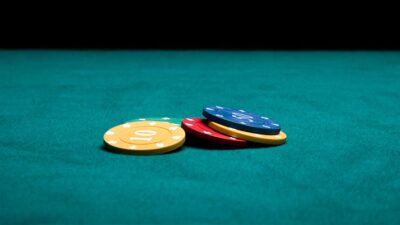 small pile of poker chips on green felt table