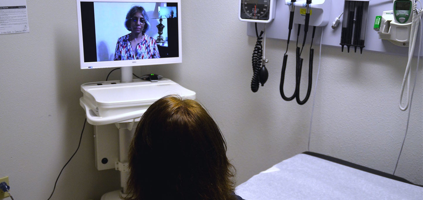 Doctor using videoconferencing for patient consultation