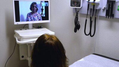 Doctor using videoconferencing for patient consultation