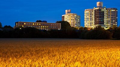 Rural hospital on the edge of a field.