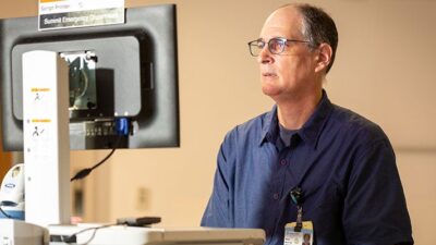 Dr. Ron Berrol using a computer to review a patient medical record.