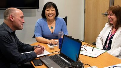 Amy Shin and two other people at a meeting