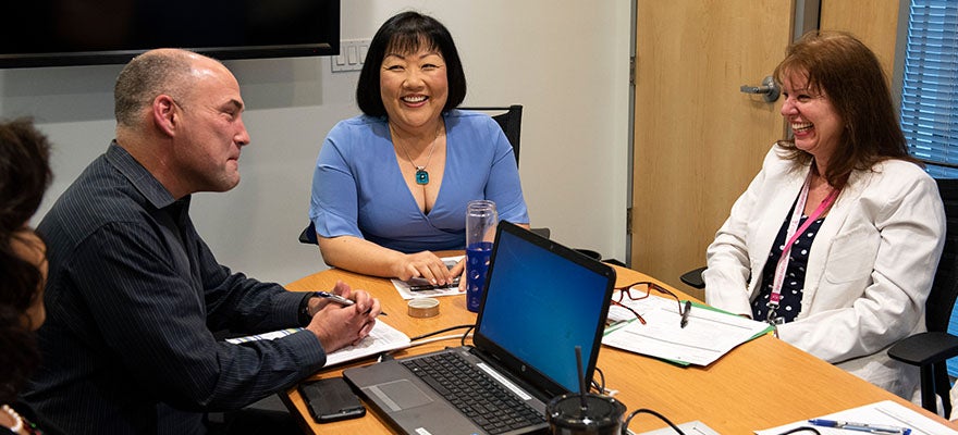 Amy Shin and two other people at a meeting