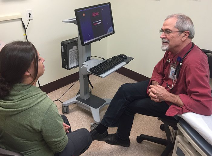 Bill Hunter speaking to a medical assistant at Open Door Community Clinic at Willow Creek in Humboldt County