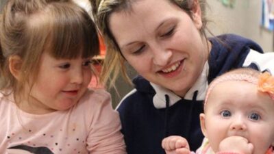 Mom holds her toddler and infant at the daycare center provided as part of her opioid treatment program