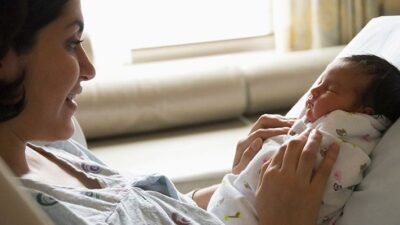 Mother holding newborn in lap