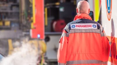 Paramedic walking next to an ambulance