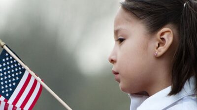 Lationo child holding an American flag