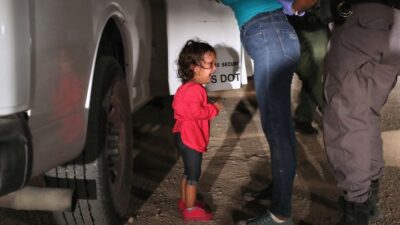 MCALLEN, TX - JUNE 12: A two-year-old Honduran asylum seeker cries as her mother is searched and detained near the U.S.-Mexico border