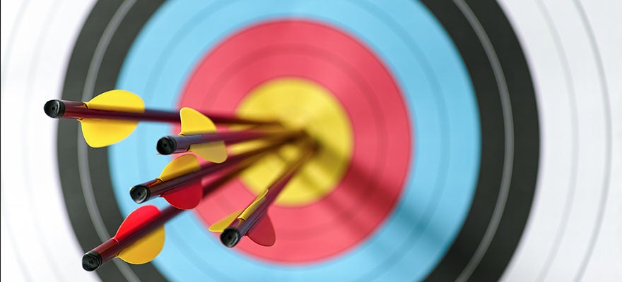 Dartboard with five arrows in the bullseye