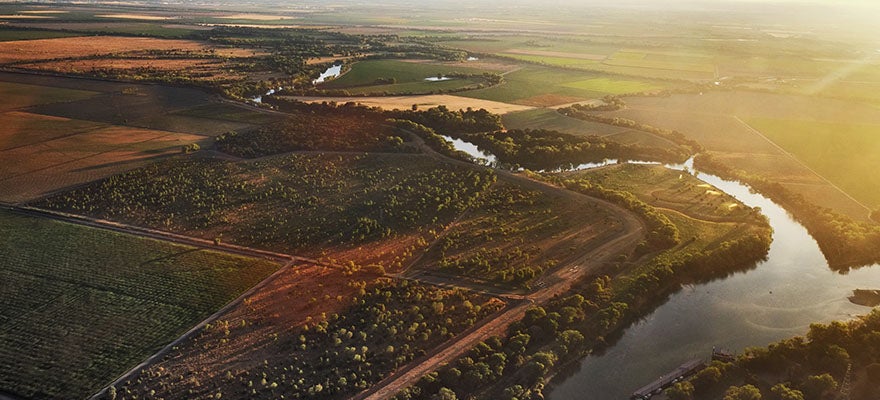River running through agricultural land.