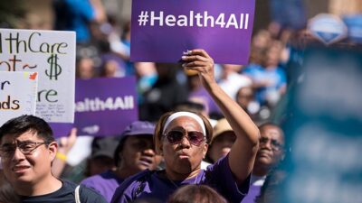Protesters march to protect the Affordable Care Act