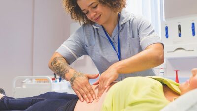 Provider or doula examines pregnant woman