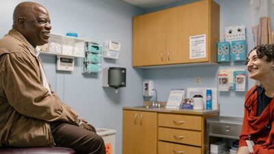 Patient and Doctor visit in exam room.