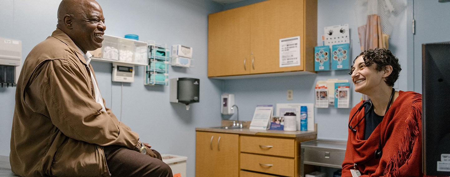 Patient and Doctor visit in exam room.