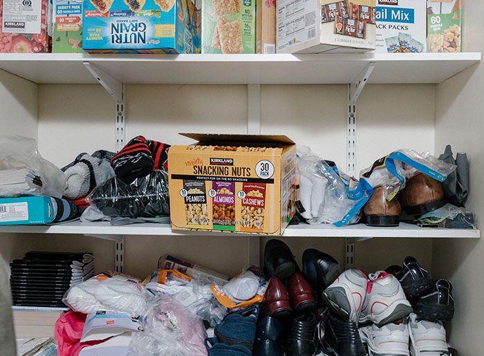 Supply closet filled with new cloting items, shoes, food and more.