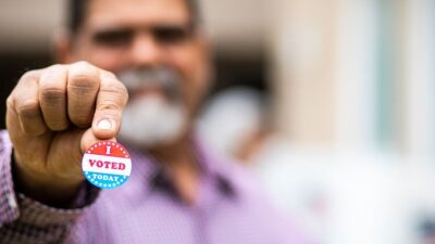 Man holding his "I Voted" sticker