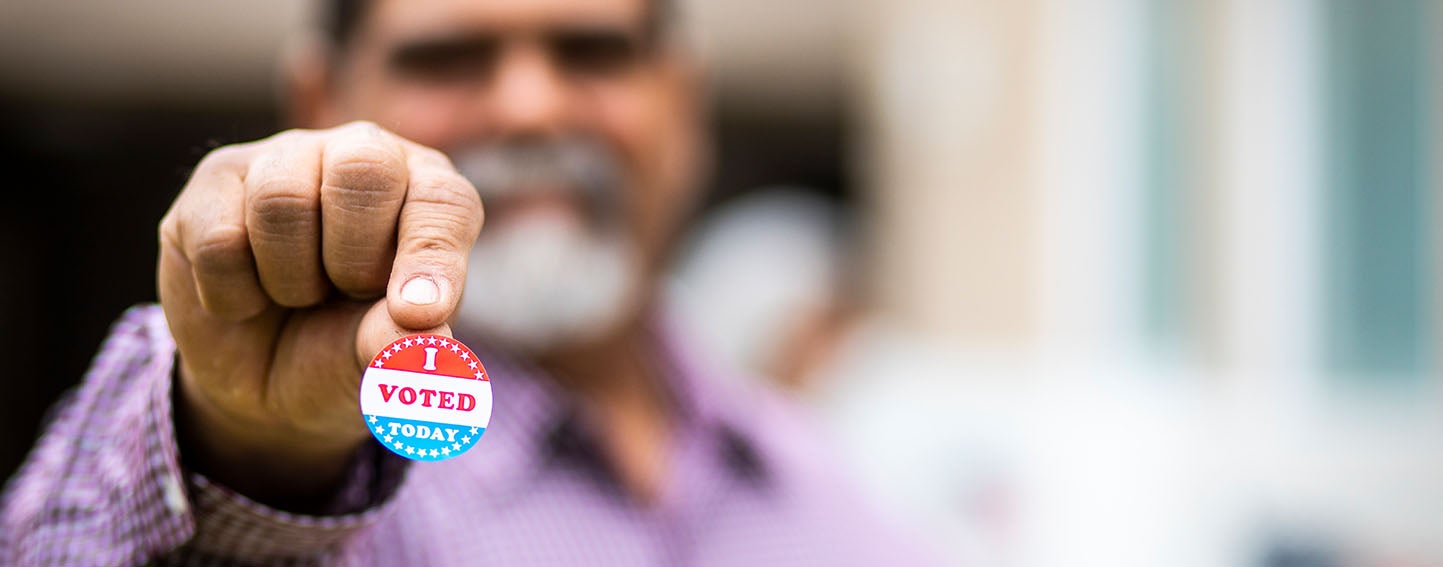 Man holding his "I Voted" sticker