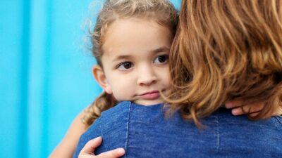 Mother holding daughter.