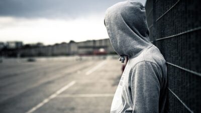 Lonely man standing in desolate urban environment.