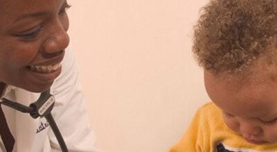 Dr. Angela Burke examines a young patient.