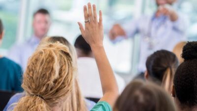 health care provider raised hand during training class