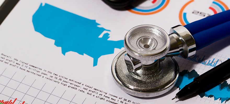 A stethoscope lays on a printed page containing a chart and a map of the United States