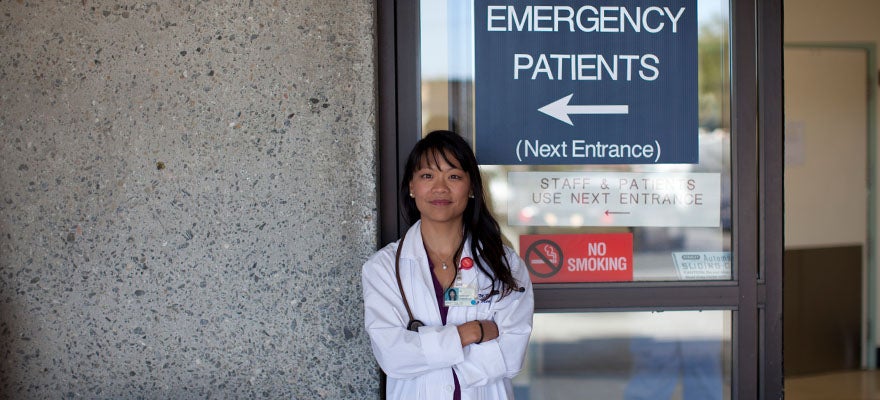 Dr. Renee Hsia stands in front of Emergency Room entrance sign.