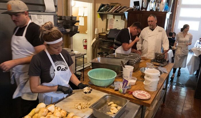 Chef Patrick Mulvaney talks with his kitchen staff