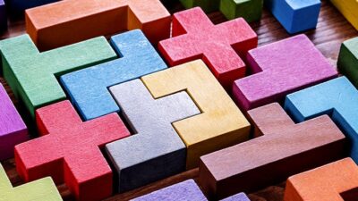 puzzle made of colorful blocks and a block that is a red cross symbol