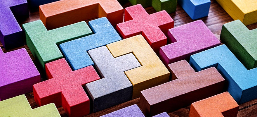 puzzle made of colorful blocks and a block that is a red cross symbol