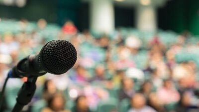 microphone set up in front of a large crowd
