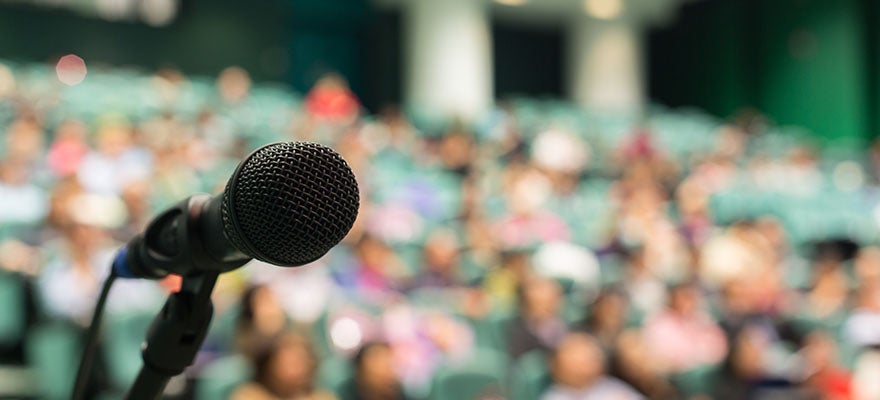 microphone set up in front of a large crowd