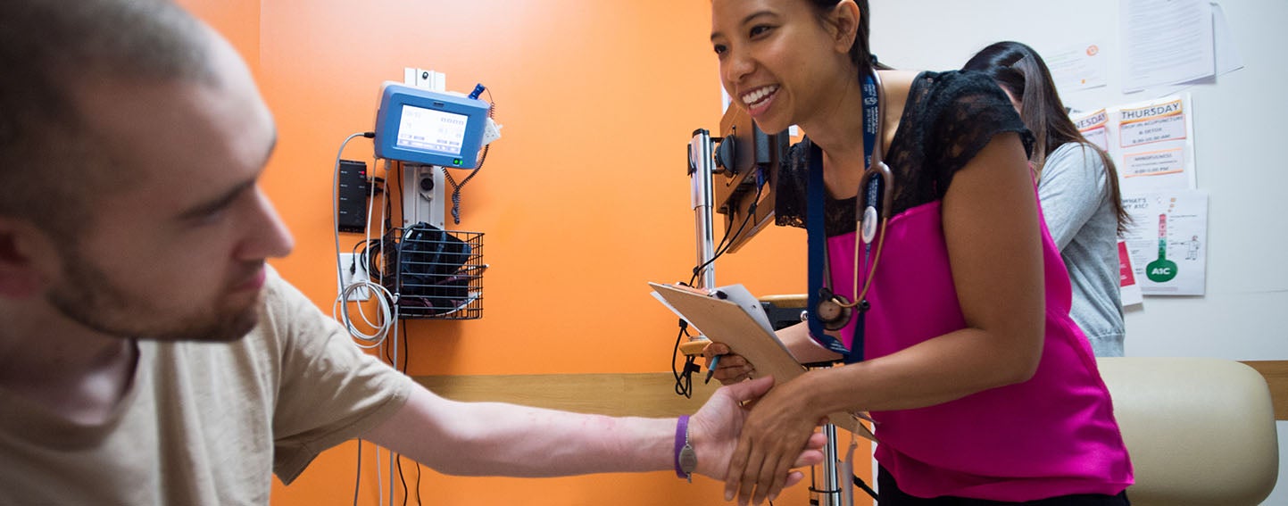 Medical practitioner shakes patient's hand.