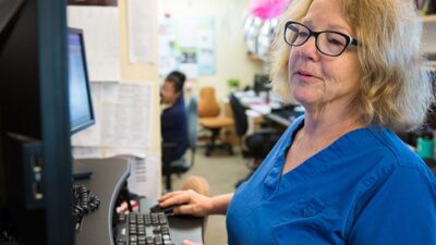 medical practitioner enters patient information into an electronic health record system