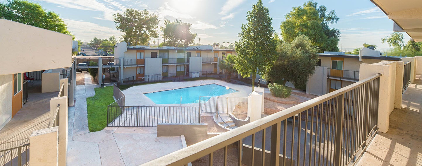 Apartment complex with swimming pool on a sunny day