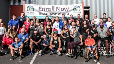 Group photo of Covered Califiornia staff with the atheletes of the Challenged Atheletes Foundation