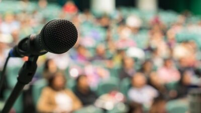 microphone set up in front of a large crowd