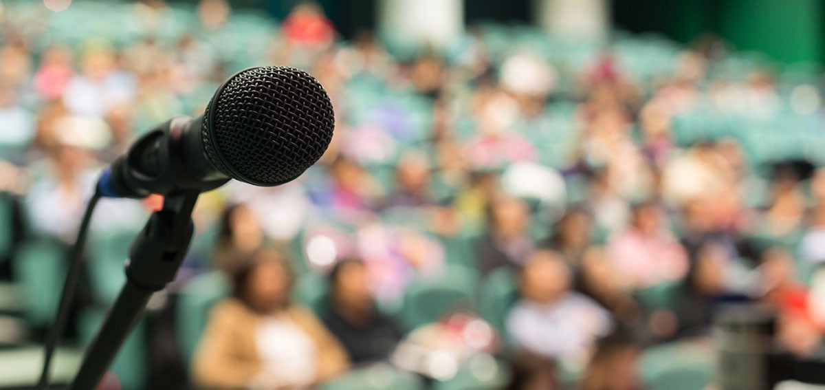 microphone set up in front of a large crowd
