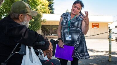Community outreach worker talks to client at West County Community Service