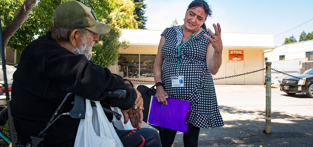 Community outreach worker talks to client at West County Community Service