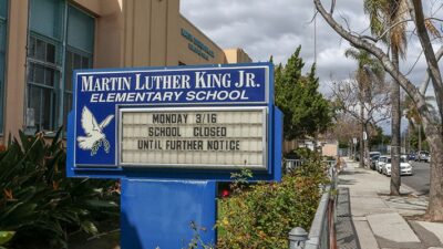 Martin Luther King Jr. Elementary School, Los Angeles, sign reads "Monday 3/16 School Closed Until Further Notice"