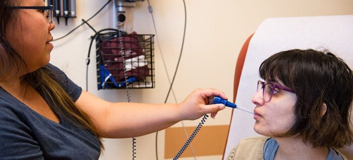 Patient having her temperature taken at a clinic.
