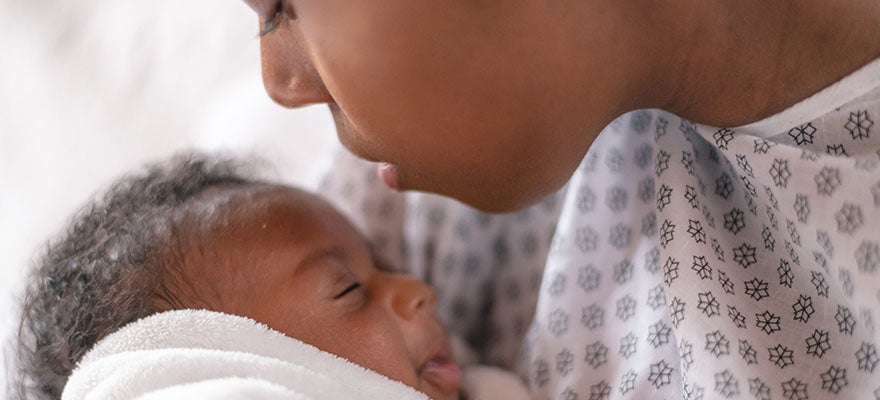 Mother with newborn baby in hospital.