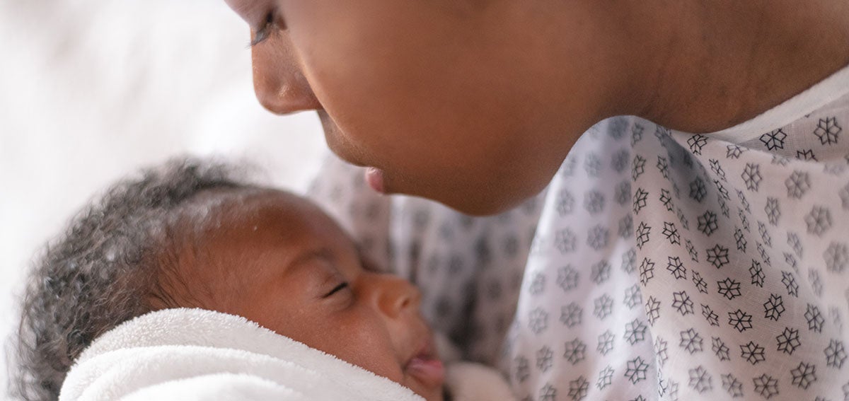 Mother with newborn baby in hospital.